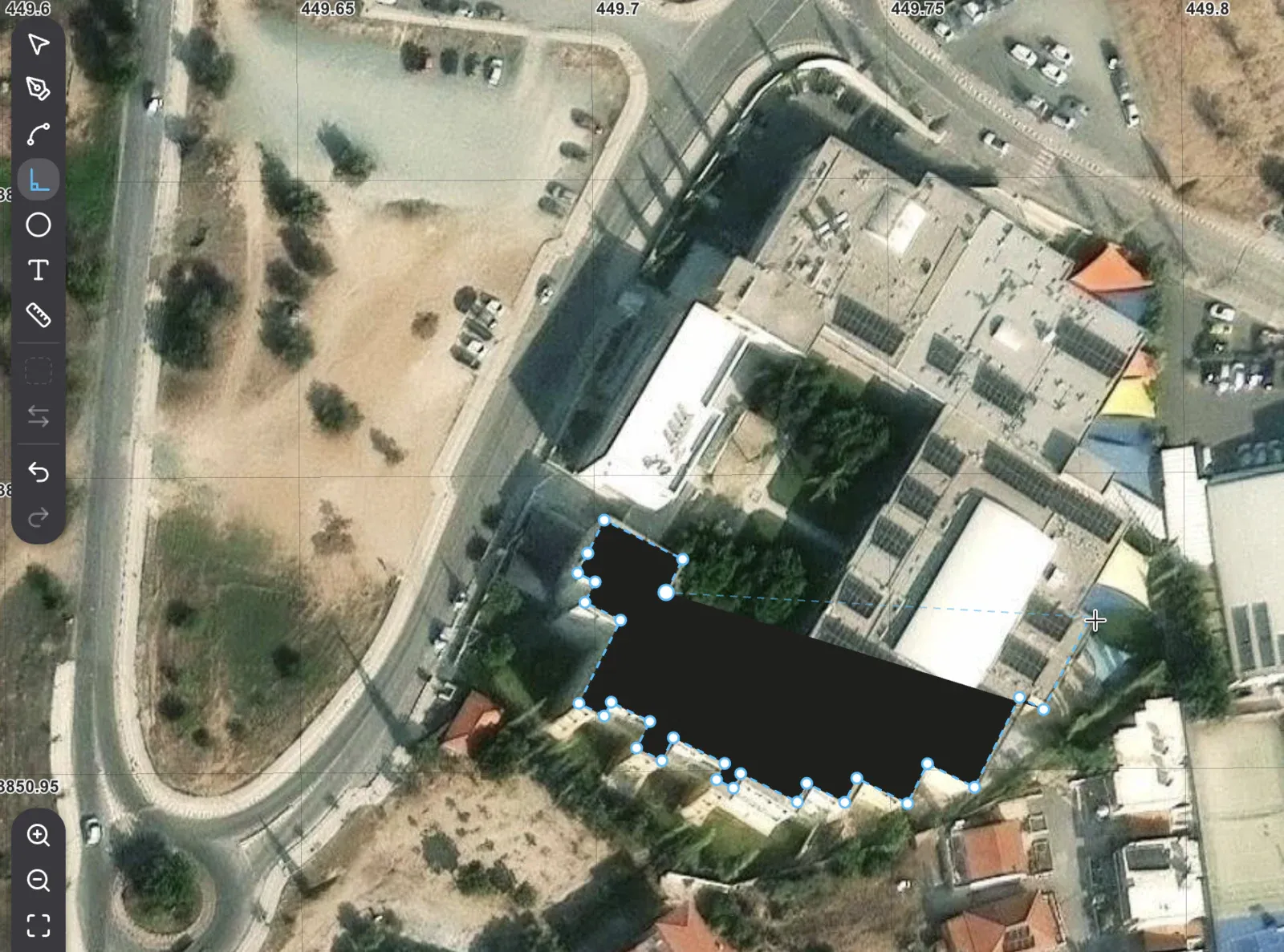 Drawing a building over satellite imagery: the outline snaps to right angles as the corners go
down.